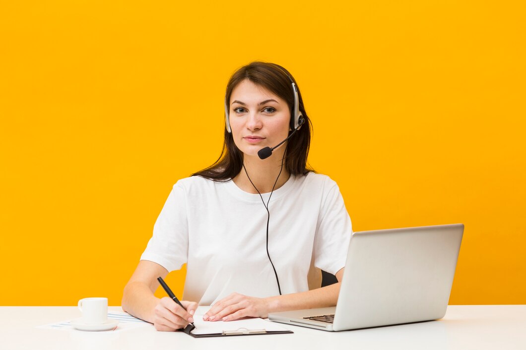 front view woman posing her desk while wearing headset 23 2148434780