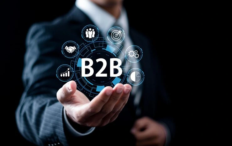 Business professional holding digital B2B icons representing client acquisition services and business networking