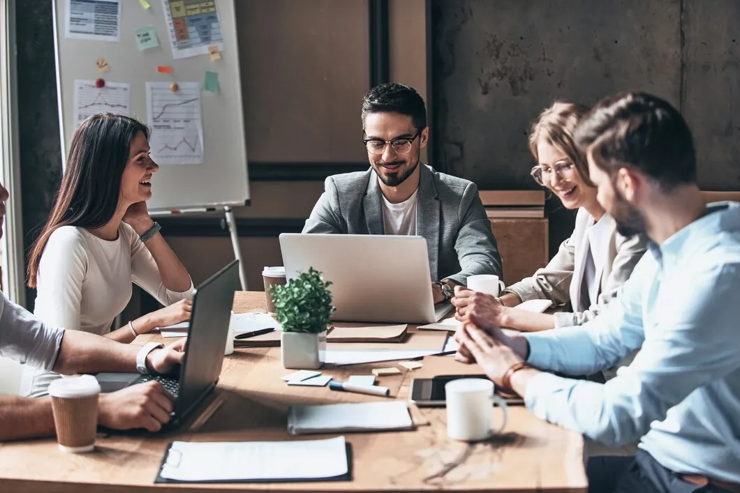 Email Marketing for Cannabis Brands 40 Professional team meeting discussing cannabis email marketing services with laptops and strategy documents