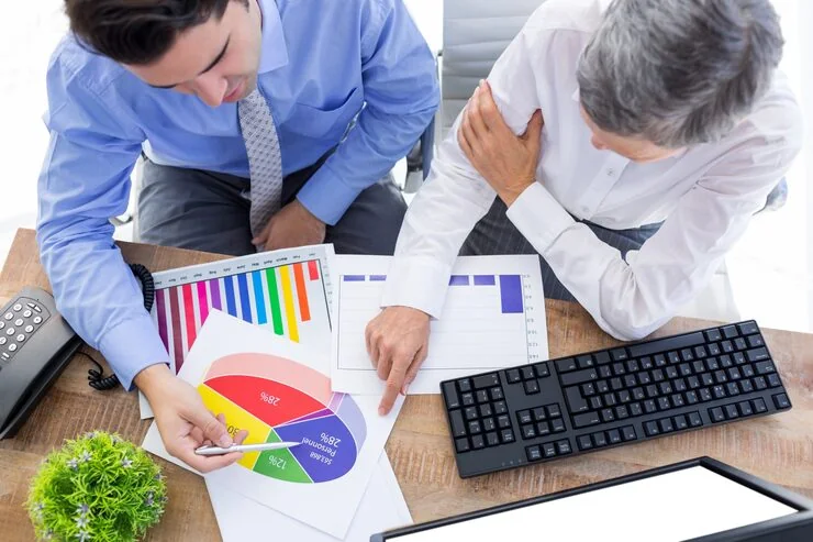 Business professionals analyzing competitor insights data with colorful charts and graphs for lead generation