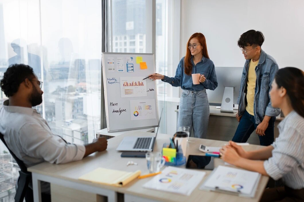 Woman presenting data charts to team in meeting